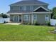 The backyard features a manicured lawn and a charming outdoor seating area at 5118 Regents Park Dr, Hickory, NC 28602