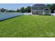 View of the expansive lawn with a white fence, showing the home's spacious outdoor area at 5118 Regents Park Dr, Hickory, NC 28602