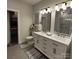 Bright bathroom with double sinks, a large vanity, tile flooring, and a well-lit mirror at 5118 Regents Park Dr, Hickory, NC 28602