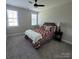 Cozy bedroom with a comfortable bed, ceiling fan, and natural light from two windows at 5118 Regents Park Dr, Hickory, NC 28602