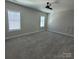 Large, well-lit bedroom with neutral walls, two windows, and carpet at 5118 Regents Park Dr, Hickory, NC 28602
