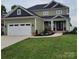 Charming two-story home with a two-car garage, lovely landscaping, and a welcoming front entrance at 5118 Regents Park Dr, Hickory, NC 28602