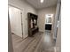 Functional hallway with a built-in mudroom bench, shoe storage, and access to a half-bathroom at 5118 Regents Park Dr, Hickory, NC 28602