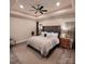Serene main bedroom with a tray ceiling, ceiling fan, soft carpet, and comfortable furnishings at 5118 Regents Park Dr, Hickory, NC 28602