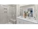 Modern bathroom featuring double sinks, a glass-enclosed shower, and neutral tiling at 518 Tayberry Ln, Fort Mill, SC 29715