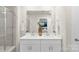Bright bathroom featuring double sinks, quartz countertops, and a glass-enclosed shower at 518 Tayberry Ln, Fort Mill, SC 29715