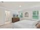 Bright bedroom showcasing neutral walls, a queen bed, and an ensuite bathroom entrance at 518 Tayberry Ln, Fort Mill, SC 29715