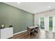 Modern dining room features a green accent wall, stylish table setting, and ample natural light at 518 Tayberry Ln, Fort Mill, SC 29715
