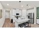 Modern kitchen featuring an island with barstools, stainless appliances and ample cabinet space at 518 Tayberry Ln, Fort Mill, SC 29715