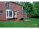 Beautiful backyard deck with steps and view of the green lawn and brick home at 601 Carver Pond Ln, Waxhaw, NC 28173