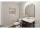 Charming powder room with a dark vanity, curved mirror, and stylish fixtures at 601 Carver Pond Ln, Waxhaw, NC 28173