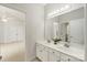 Double vanity bathroom with neutral tones, a large mirror, and views into the bedroom and toilet area at 601 Carver Pond Ln, Waxhaw, NC 28173