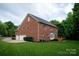 Sprawling brick home with a three-car garage and lush green lawn at 601 Carver Pond Ln, Waxhaw, NC 28173
