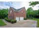 Beautiful brick home featuring a three-car garage, manicured landscaping, and well-kept driveway at 601 Carver Pond Ln, Waxhaw, NC 28173