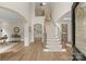 Bright foyer featuring high ceilings, hardwood floors, staircase, and open view to other rooms at 601 Carver Pond Ln, Waxhaw, NC 28173