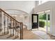 Inviting foyer with an open entryway, beautiful hardwood floors, staircase and a view of the dining room at 601 Carver Pond Ln, Waxhaw, NC 28173