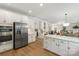 Spacious kitchen with stainless steel appliances, island, and seamless flow to dining and living areas at 601 Carver Pond Ln, Waxhaw, NC 28173