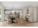 Spacious open kitchen with white cabinets, hardwood floors, and eat-in area with plenty of space at 601 Carver Pond Ln, Waxhaw, NC 28173