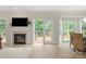 Bright living area featuring a fireplace, access to the deck, and lots of natural light at 601 Carver Pond Ln, Waxhaw, NC 28173