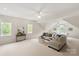Spacious recreation room with a ping pong table, comfortable seating area, and natural light from multiple windows at 601 Carver Pond Ln, Waxhaw, NC 28173