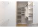 Organized walk-in closet with shelving and hanging rods for optimal storage solutions and convenience at 601 Carver Pond Ln, Waxhaw, NC 28173