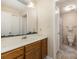 This bathroom offers a combination of neutral walls, wooden cabinets and a framed mirror above the sink at 6011 Treetop Ct, Charlotte, NC 28212