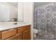 Functional bathroom featuring neutral tones, wood vanity and shower/tub combination at 6011 Treetop Ct, Charlotte, NC 28212
