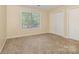 This bedroom features neutral carpeting, walls, and window coverings for a clean, bright space at 6011 Treetop Ct, Charlotte, NC 28212