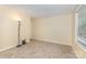 Bedroom showcasing light, neutral walls, plush carpeting, and a brightly lit window with adjustable blinds at 6011 Treetop Ct, Charlotte, NC 28212