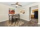 Open dining area with view of kitchen, featuring a modern table and stylish chairs at 6011 Treetop Ct, Charlotte, NC 28212