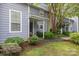 Inviting covered porch area surrounded by lush, green landscaping at 6011 Treetop Ct, Charlotte, NC 28212