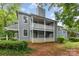 Exterior view of a two story gray house with white railings and green yard at 6011 Treetop Ct, Charlotte, NC 28212