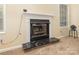 Cozy fireplace with black marble hearth and white mantle, perfect for chilly evenings at 6011 Treetop Ct, Charlotte, NC 28212