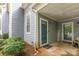 Charming front porch with stylish door, welcome mat, and lovely landscaping at 6011 Treetop Ct, Charlotte, NC 28212