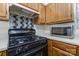 Close up of the kitchen with stainless steel microwave and modern range at 6011 Treetop Ct, Charlotte, NC 28212