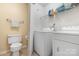 This laundry room features a washing machine, dryer, toilet and storage space at 6011 Treetop Ct, Charlotte, NC 28212