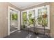 Sunroom with multiple windows, a carpeted floor, and a variety of potted plants decorating the space at 6011 Treetop Ct, Charlotte, NC 28212