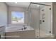 Bright bathroom featuring a soaking tub and a glass-enclosed shower with white subway tile at 6027 Veld Ct # 82, Charlotte, NC 28215