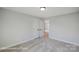 Bright bedroom with plush carpeting, light gray walls, and open doorway to the hall at 6027 Veld Ct # 82, Charlotte, NC 28215