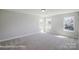 Bedroom with plush carpeting, abundant natural light, and neutral walls at 6027 Veld Ct # 82, Charlotte, NC 28215
