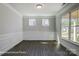 Formal dining room with wainscoting, large windows, and hardwood floors at 6027 Veld Ct # 82, Charlotte, NC 28215
