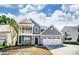 Charming two-story home featuring a covered porch, a two-car garage, and a beautifully landscaped front yard at 6027 Veld Ct # 82, Charlotte, NC 28215
