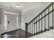 Bright foyer featuring hardwood floors, decorative trim, and a staircase with wood and iron railings at 6027 Veld Ct # 82, Charlotte, NC 28215