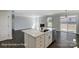 Open-concept kitchen with a center island, stainless steel appliances, and adjacent living room with fireplace at 6027 Veld Ct # 82, Charlotte, NC 28215