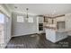 Spacious kitchen featuring a large island, white cabinetry, stainless steel appliances, and a dining area at 6027 Veld Ct # 82, Charlotte, NC 28215