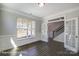 Home office with glass french doors, wainscoting, and hardwood floors at 6027 Veld Ct # 82, Charlotte, NC 28215