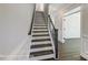 Staircase with hardwood steps and dark wood railing at 6027 Veld Ct # 82, Charlotte, NC 28215