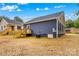 Spacious backyard featuring a new wooden deck and vibrant landscaping, perfect for outdoor living and entertaining at 630 W Bell St, Statesville, NC 28677