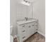 Bathroom vanity with granite countertops, black hardware and fixtures, and storage cabinets at 630 W Bell St, Statesville, NC 28677