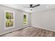 Bright bedroom featuring hardwood floors, a ceiling fan, recessed lights and large windows at 630 W Bell St, Statesville, NC 28677